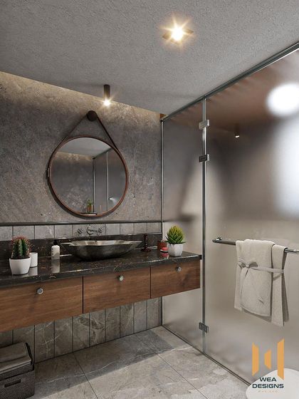 A close-up of the floating vanity with its glass bowl sink and a unique leather-belt-hung circular mirror.