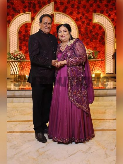 A beautiful couple, with the lady dressed in a custom-made purple gown with an embroidered jacket. A perfect look for a family wedding reception.