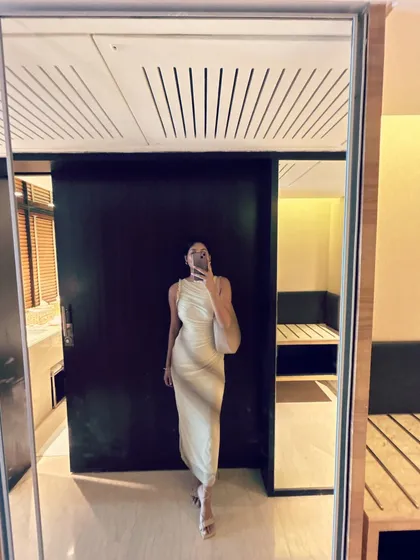 A mirror selfie of my look for a Netflix promotional event. This elegant, cream-colored draped dress is a perfect example of understated glamour.