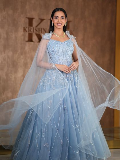 A modern, fashion-forward look featuring a pearl-encrusted gown. The simple diamond drop earrings are the perfect accessory for this statement outfit.