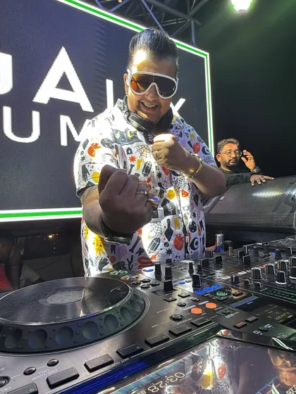 In my zone behind the decks on the baraat truck. This is the command center where I orchestrate the entire musical journey, ensuring the energy never drops for a single moment.