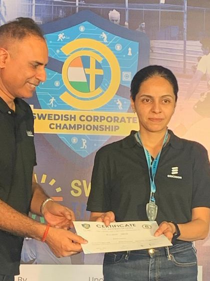 A participant receiving her certificate at the Swedish Corporate Championship. I am proud to see our community members succeed in various tournaments, a testament to their dedication.