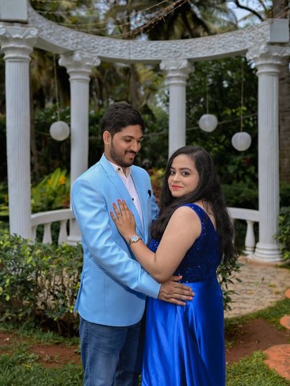 A romantic moment in the garden, with the white colonnade structure in the background.
