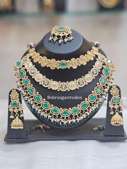 A unique layered necklace set combining different styles of chokers for a very grand look.