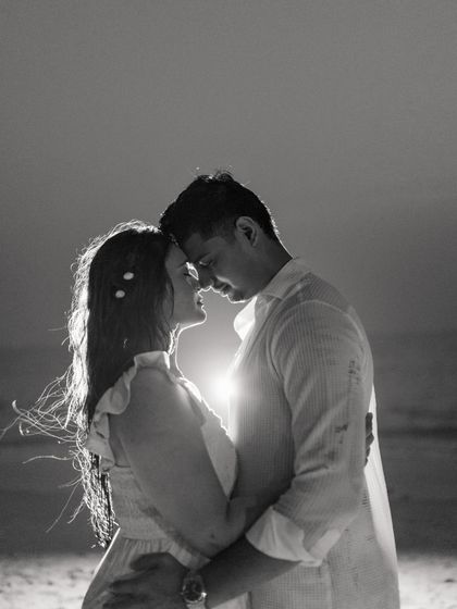 A beautiful black and white portrait of the couple in a tender embrace. The backlighting creates a magical glow, highlighting their connection and the intimacy of the moment.