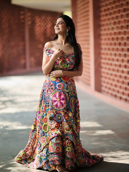 A happy, sun-kissed shot that brings out the joyful colors of the lehenga. I believe in creating looks that feel alive and full of personality.