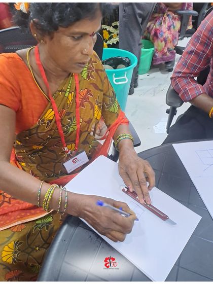 The first step in design is often putting pencil to paper. Here, a participant in our Nellore workshop sketches out her design ideas, learning the principles of form and structure before bringing her vision to life with flowers.