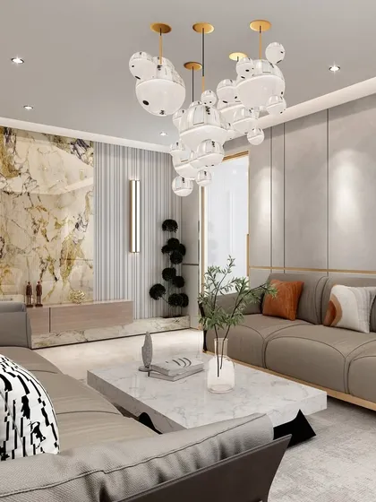 This living room showcases a maximalist design balanced with muted walls. A stunning marble feature wall and a unique bubble chandelier create a sense of drama and luxury.