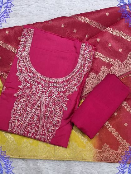 A stunning fuchsia and yellow unstitched suit set. The pink top has intricate silver embroidery and is paired with a dual-toned Banarasi dupatta.