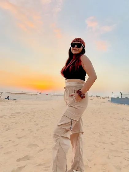 Posing against the beautiful sunset in the Dubai desert. I paired a simple black crop top with comfortable beige cargo pants for the safari adventure.