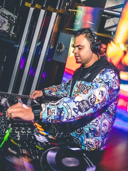 Focused in the zone, mixing tracks at a high-energy club night. A good set is a journey, and here I am crafting the experience, blending beats, and reading the room to keep the party going strong.