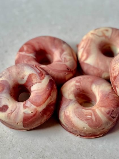 A close-up of the Sweet Rose donut soaps, showing the beautiful, natural swirl of the French pink clay.