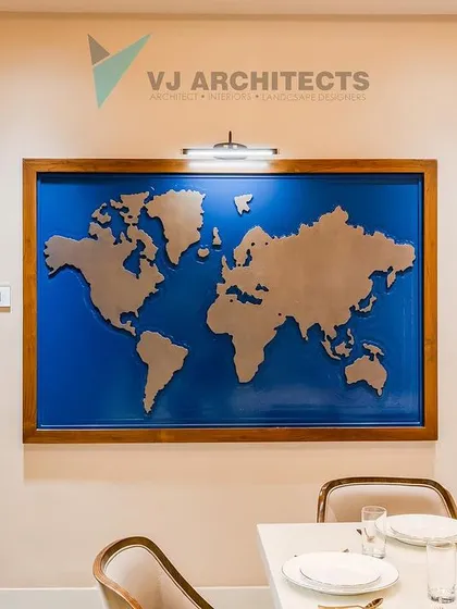 A closer look at the world map feature wall, positioned next to a traditionally carved wooden door frame. This juxtaposition of global modernism and local heritage is central to the home's design story.
