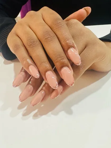 Elegant and subtle. These nude nails are enhanced with a very fine, sparkling glitter French tip for a hint of glamour that's perfect for everyday wear.