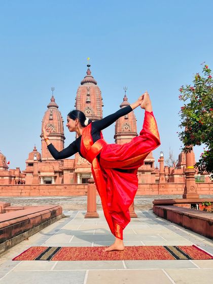 Performing Natarajasana at the Laxminarayan Temple. I believe every woman is powerful and beautiful, and this pose is an expression of that divine feminine strength and grace.