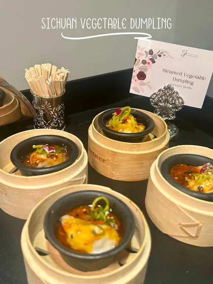Sichuan Vegetable Dumplings, served in individual bamboo steamers with a flavourful broth, offering a complete bite-sized experience.