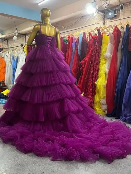 A side view of our purple ruffled gown, showing the incredible volume and length of the train. This dress is guaranteed to make a statement in your photos.