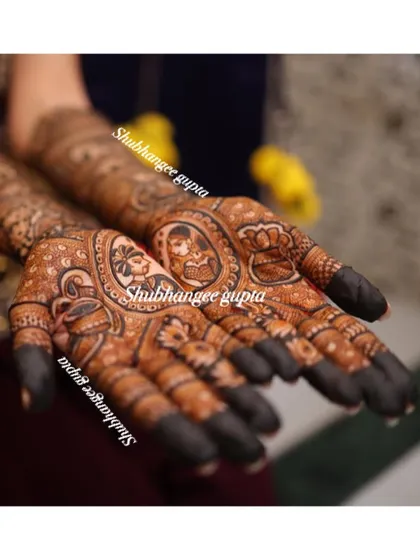 A close up shot of the beautiful stain from a bridal design. You can see the clear portraits of the couple, surrounded by delicate patterns. This is the result of good henna and proper aftercare.