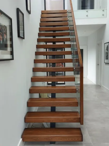 The slender profile of the centre-spine staircase allows light to pass through, making the hallway feel larger and more welcoming.