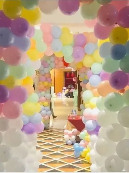 An enchanting entrance made of multiple pastel balloon arches. This creates a beautiful tunnel for guests to walk through as they enter the party.