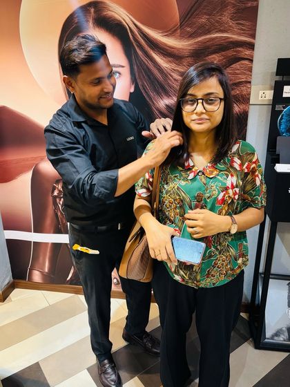 The client and stylist duo, capturing the successful hair transformation and the happy result.