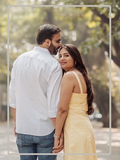 A sweet and simple portrait, framed to draw all the attention to the couple's connection. Her look back at the camera is both engaging and natural.