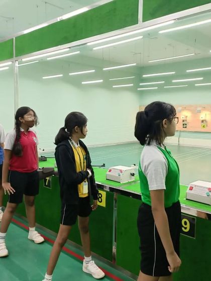 Young students from Greenwoods High line up, listening to instructions before their turn to shoot. Discipline and attentiveness are core values we instill in all our youth programs.
