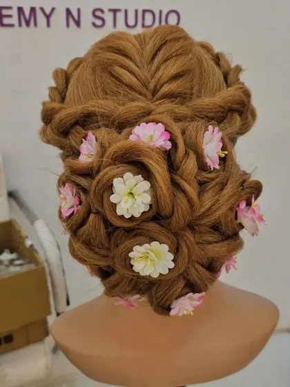 Hairstyling is a key skill for any professional artist. Here is an intricate floral updo created on a mannequin during a practice session. My course covers everything from basic braids to complex international bridal updos.