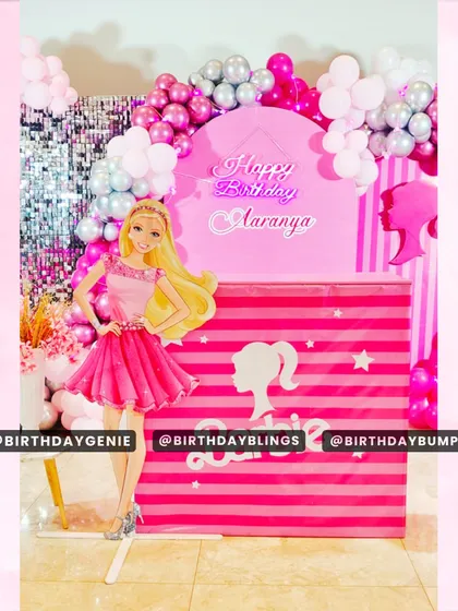 A close-up of the central photo booth area for the Barbie party, showing the personalized neon sign and branded cake table.