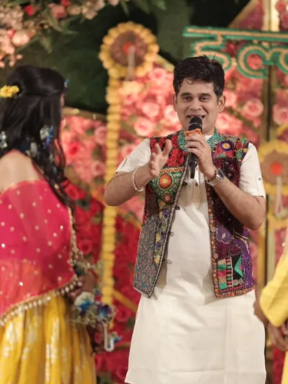 My expressive style of hosting in action. I use hand gestures and an engaging tone to keep the audience captivated during daytime ceremonies.