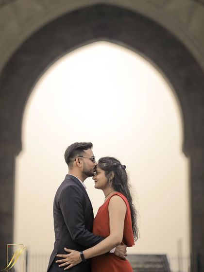 A classic and intimate pre-wedding portrait at the Gateway of India. I used the archway to frame the couple, creating a beautiful silhouette effect that focuses on the tender moment of a kiss on the forehead.