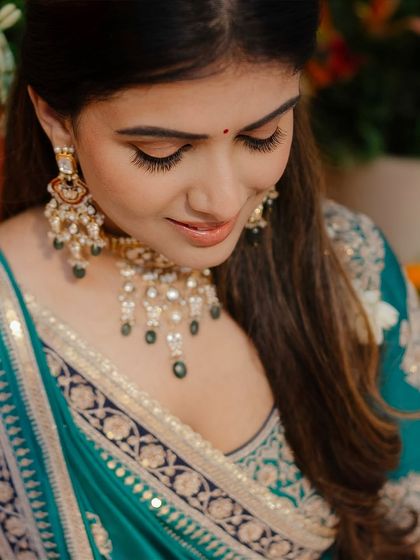 Embracing tradition for a mehendi ceremony. This look features soft, defined eyes and a neutral lip to complement the rich teal outfit.