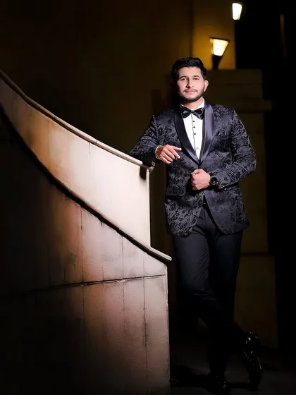 A classic, suave portrait of the groom. The dramatic side-lighting creates a timeless and elegant look.