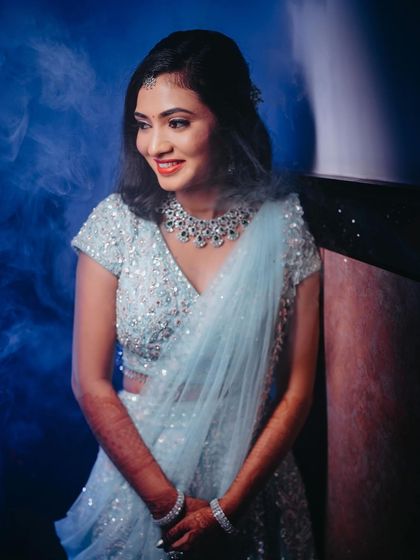 A creative shot with blue smoke, giving Rakshita's reception look an ethereal and modern vibe.