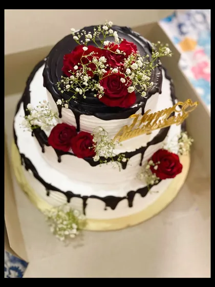 A view of the three-tier anniversary cake as it's being boxed up, showing its impressive size.