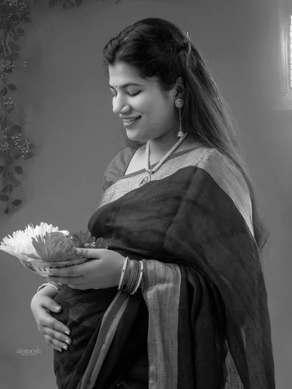 A black and white version of the traditional portrait, which adds a timeless and classic feel. It highlights the mother's serene expression and the intricate details of her attire.
