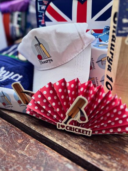 A custom-printed cap and themed paper fan, showing how every element contributes to the story.