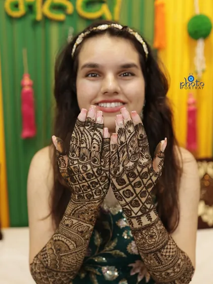 A classic pose for the bride to showcase her detailed Mehndi design. We make sure to get clear, beautiful shots of the henna art.