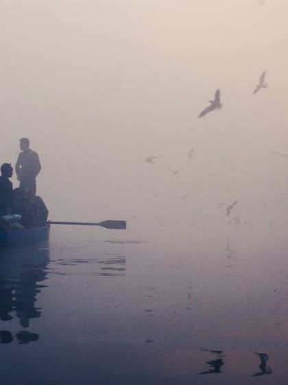 As the sun begins to burn through the fog, the scene is washed in a warm, hazy light. This photo captures that magical moment of transition between dawn and day.