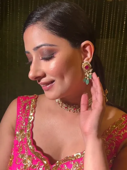 A pop of pink for a bridesmaid or guest look. This style features a soft smokey eye with pink undertones, paired with glowing skin for a fresh and festive feel.