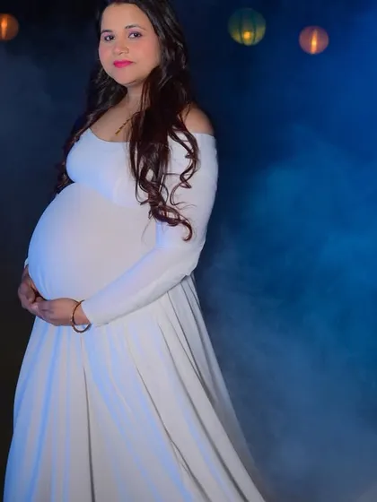 We provide a beautiful and dramatic setting for maternity photoshoots. This shot uses atmospheric smoke and soft lighting to create an ethereal portrait, highlighting this special time.