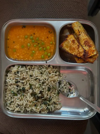 A delicious meal of methi rice, green peas dal, and pan-fried paneer. This is a flavorful and nutritious vegetarian lunch option.