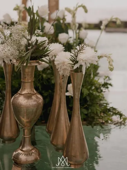 Simple, elegant details like these brass vases filled with fresh white flowers add a touch of understated luxury to the decor.