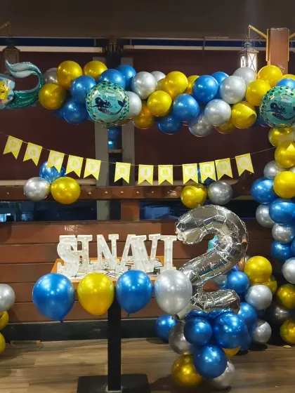 A Little Mermaid-themed balloon setup at a restaurant, showing how we can decorate around existing furniture and structures.