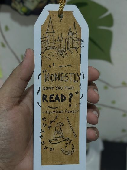 A custom Harry Potter themed bookmark I made. I illustrated Hogwarts and added a classic Hermione quote, all with a coffee-painted background. It's a fun example of a fandom-inspired piece.