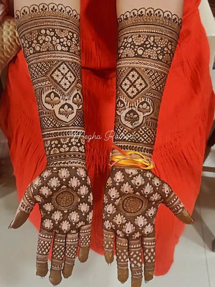 This design is filled with repeating lotus patterns on the palms, creating a beautiful floral jaal. The arms feature geometric diamond shapes with hanging elements for a touch of modern flair.