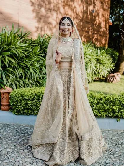 A full-length shot of my unique bride Nirali in her all-golden lehenga. The makeup was designed to be luminous and radiant to create a cohesive, magical look.