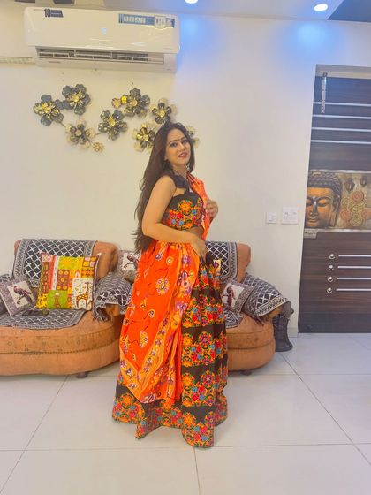 A full-length shot of the client in her black and orange Garba outfit, perfect for a night of dancing.