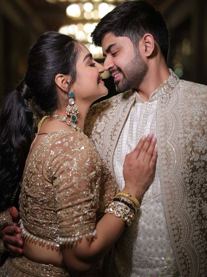 A close-up of our coordinated engagement attire. His embroidered jacket and my shimmering lehenga create a look of pure elegance, perfect for such a milestone event.