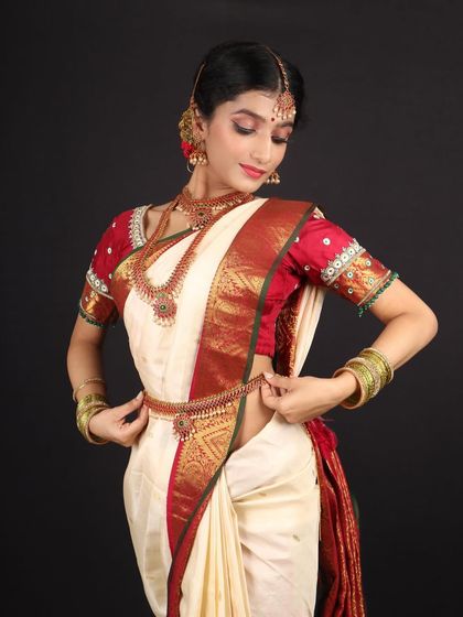 Adjusting the saree, this shot gives a full view of the traditional attire and how the subtle makeup look enhances her natural beauty.